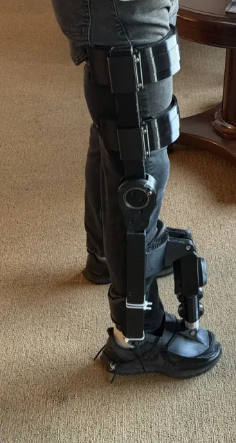 Black Kicker worn with thigh cuffs and a knee hinge